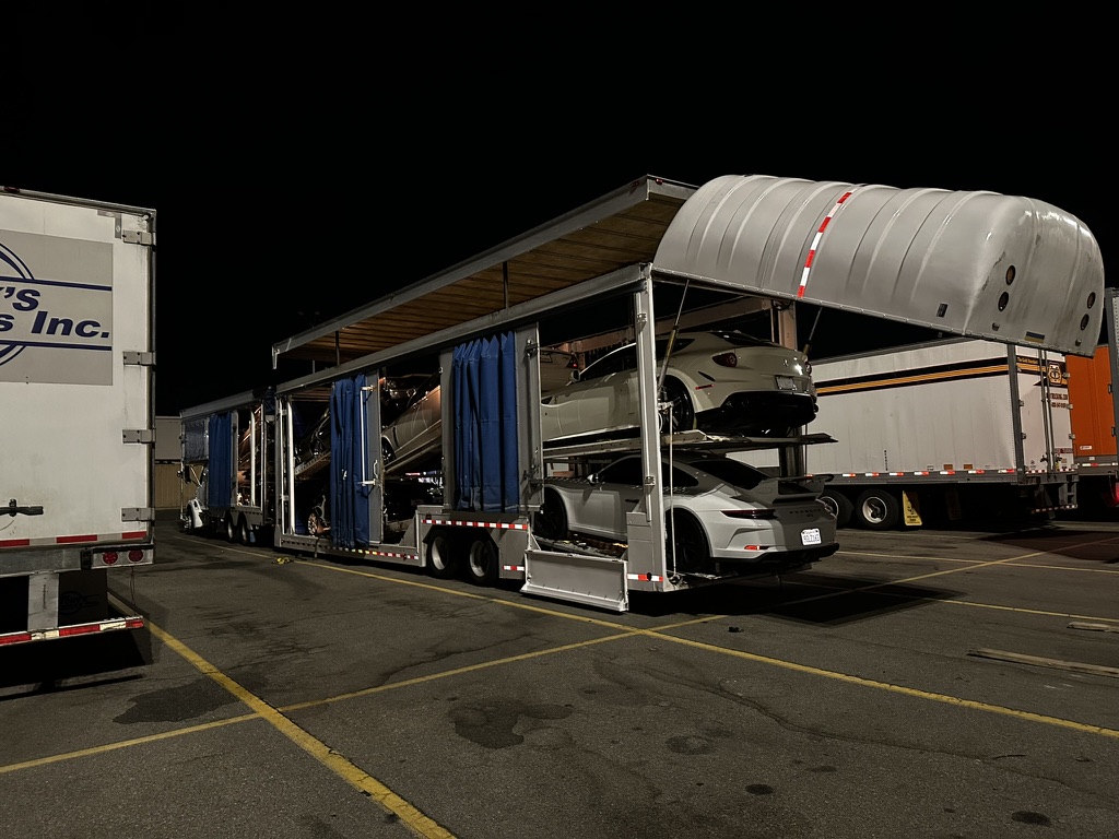 Loaded enclosed car carrier at night