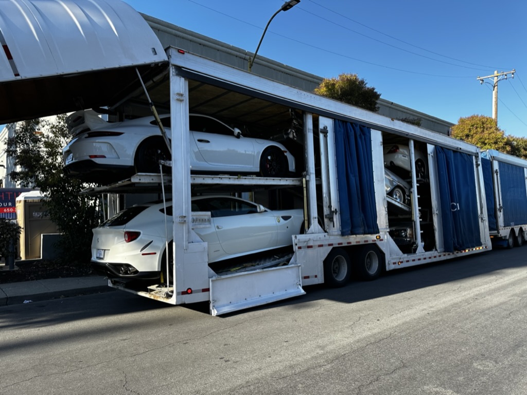 Exotic cars loaded inside a protected multi-level carrier
